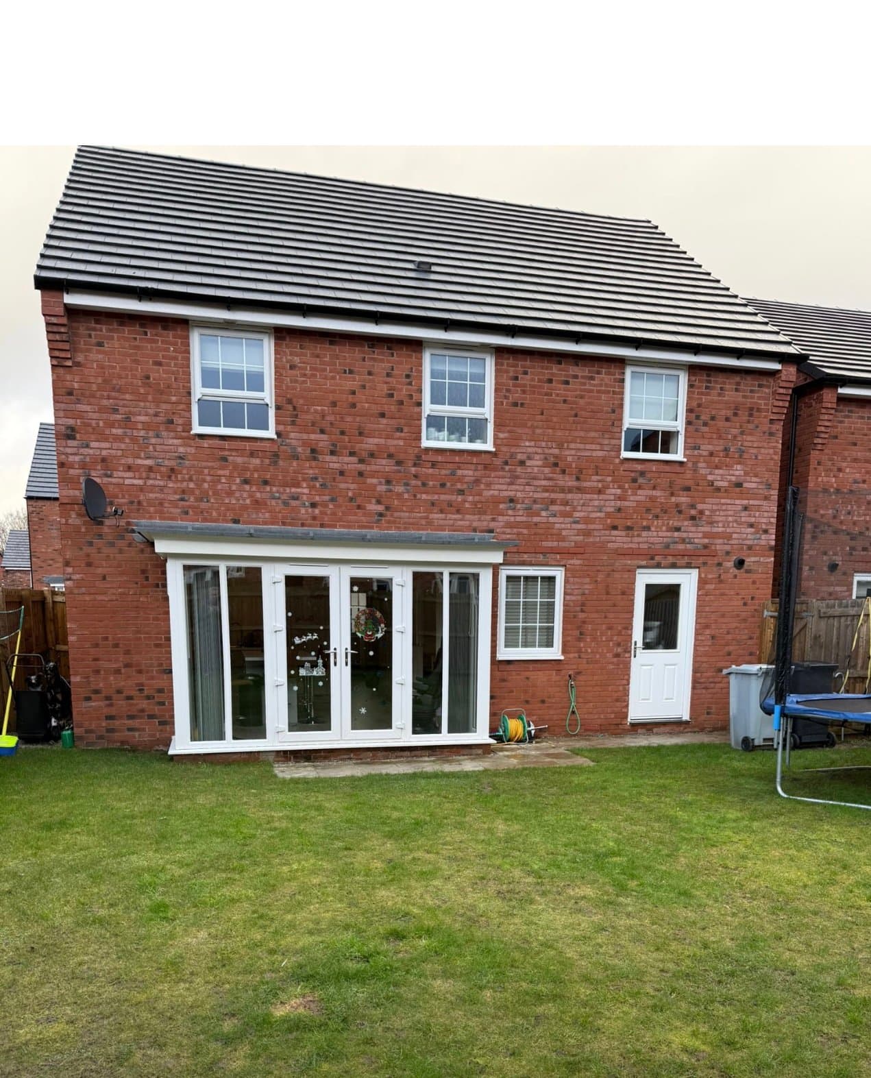 Finished porcelain patio and new lawn on a new-build garden in Chelford