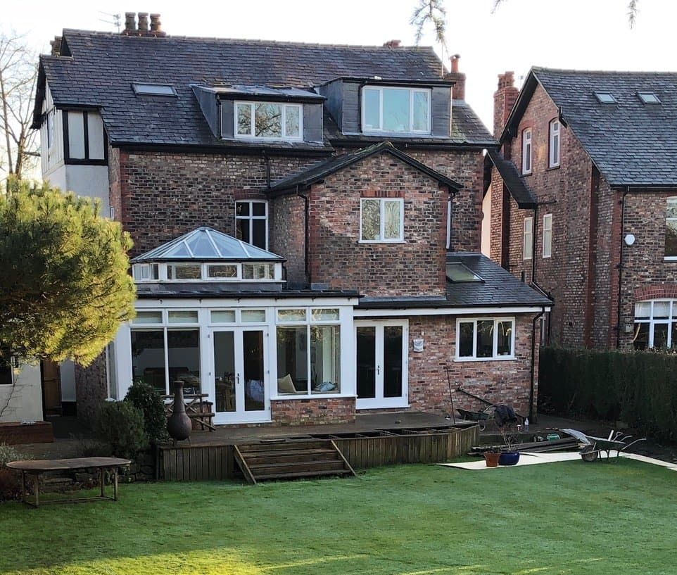 Custom curved brick pond with a gentle fountain, part of the completed Park Road, Hale garden transformation