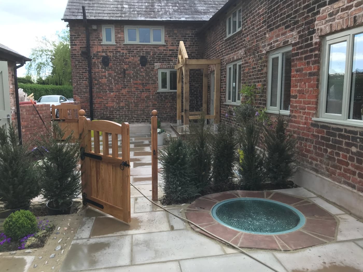 Newly planted pleached trees providing structure and privacy within the Yew Tree Farm courtyard