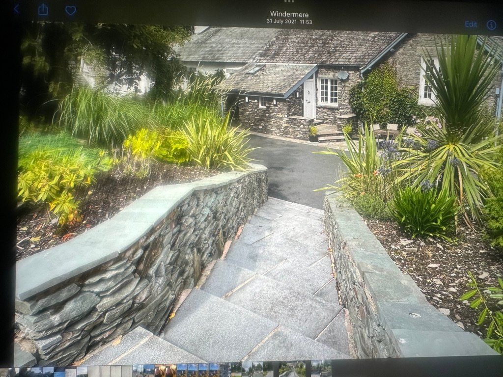 After image of a residential garden at Crook Lane, Windermere prior to our bespoke garden design and build. The space featured uneven levels and a sloped lawn requiring structural planning and regrading.