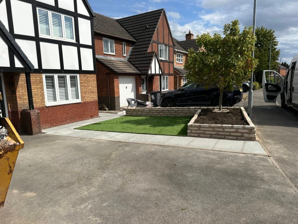 Finished front garden on White Park Close, Middlewich: fossil buff sandstone path, rectangular artificial lawn and raised planter